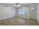 Bright living room with a ceiling fan, a large window, and an entrance door that provides natural light at 141 Larson Dr, Summerville, SC 29485