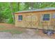 The backyard shed has double doors, two windows and lawn equipment in front of it at 141 Larson Dr, Summerville, SC 29485