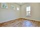 Empty bedroom with multiple windows and wood-style floors providing natural light at 1423 Clay Field Trl, Summerville, SC 29485