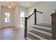Inviting entryway with wood flooring, a staircase, and a front door with glass panels at 1423 Clay Field Trl, Summerville, SC 29485