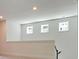 Bright loft area with natural light showcasing staircase at 1423 Clay Field Trl, Summerville, SC 29485
