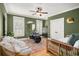 Inviting room with hardwood floors, stylish light fixture, window with shutters, and a drum set as decor at 1543 Wando Landing St, Charleston, SC 29492