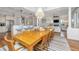 Open concept dining room with a wood table, chandelier, and view into the kitchen and living room at 1543 Wando Landing St, Charleston, SC 29492