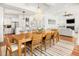 Open-concept dining room with a chandelier, wood table, and views into the kitchen and living room at 1543 Wando Landing St, Charleston, SC 29492