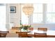 Elegant dining room with a chandelier, wood table, and view of the bright outdoors at 1543 Wando Landing St, Charleston, SC 29492
