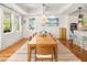 Bright dining room featuring a wood table, chandelier, wainscoting, and ample natural light at 1543 Wando Landing St, Charleston, SC 29492