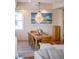 Dining room with a wood table, chandelier, wainscoting, and painting of a seascape at 1543 Wando Landing St, Charleston, SC 29492