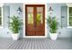 Inviting front entrance featuring double doors, potted plants, and stylish sconces at 1543 Wando Landing St, Charleston, SC 29492