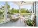 Inviting front porch with wicker furniture, and charming decor at 1543 Wando Landing St, Charleston, SC 29492