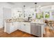 Kitchen island with granite countertops, stainless steel dishwasher, and white cabinetry at 1543 Wando Landing St, Charleston, SC 29492
