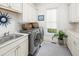 Well-organized laundry room with modern washer and dryer, sink, and ample storage at 1543 Wando Landing St, Charleston, SC 29492