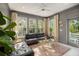 Bright living room featuring black leather sofas, a gold coffee table and neutral decor at 1543 Wando Landing St, Charleston, SC 29492