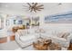 Open-concept living room with a white sectional, view into dining room, and hardwood floors at 1543 Wando Landing St, Charleston, SC 29492