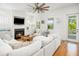 Comfortable living room with a fireplace, white sectional sofa, and access to a balcony at 1543 Wando Landing St, Charleston, SC 29492