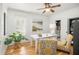 Bright office space with a white desk, floral chairs, shutters, and a potted plant at 1543 Wando Landing St, Charleston, SC 29492