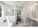 Bright bathroom with a tub, shower, and gray vanity at 164 Wappoo Trace Ln, Summerville, SC 29486