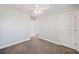 A cozy bedroom is carpeted and freshly painted, illuminated by a modern ceiling fan, and includes two white doors at 164 Wappoo Trace Ln, Summerville, SC 29486