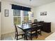 Dining room with wood table, chairs, buffet, natural light from the window at 164 Wappoo Trace Ln, Summerville, SC 29486