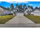 Charming two-story home with gray siding, an attached garage, a well-manicured lawn, and lush, mature trees at 164 Wappoo Trace Ln, Summerville, SC 29486