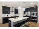 Modern kitchen features a center island with quartz countertops, stainless appliances, and dark cabinetry at 164 Wappoo Trace Ln, Summerville, SC 29486