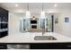 Modern kitchen with stainless steel appliances and an expansive island that opens to a cozy, connected living room at 164 Wappoo Trace Ln, Summerville, SC 29486