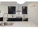 Close up shot of the kitchen area that features black cabinets, subway tile backsplash and stainless steel appliances at 164 Wappoo Trace Ln, Summerville, SC 29486