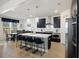 Modern kitchen with stainless steel appliances, a large island with seating, and an adjacent dining area at 164 Wappoo Trace Ln, Summerville, SC 29486