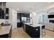 Open kitchen and living area with stainless steel appliances, large island, and modern finishes at 164 Wappoo Trace Ln, Summerville, SC 29486