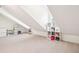 Spacious, well-lit attic with carpet flooring and built in shelving at 174 Revetment Ln, Mount Pleasant, SC 29464