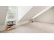 Well-lit attic featuring carpet flooring and a window with blinds at 174 Revetment Ln, Mount Pleasant, SC 29464