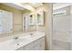 Bright bathroom featuring a double vanity with access to a tiled shower with tub at 174 Revetment Ln, Mount Pleasant, SC 29464