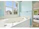 Bright bathroom featuring a bathtub with a large window offering a pleasant outdoor view at 174 Revetment Ln, Mount Pleasant, SC 29464