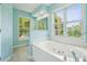 Bright bathroom featuring a jetted tub with large windows offering a pleasant outdoor view at 174 Revetment Ln, Mount Pleasant, SC 29464