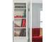 Built-in bookshelf showcasing an array of books, leading to a view of a red sofa in the next room at 174 Revetment Ln, Mount Pleasant, SC 29464