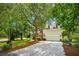 Charming two-story home with brick and siding, mature trees, an orange front door, and an attached garage at 174 Revetment Ln, Mount Pleasant, SC 29464