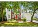 Charming two-story home featuring a brick facade, siding, a welcoming orange front door, and a landscaped yard at 174 Revetment Ln, Mount Pleasant, SC 29464