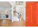 Bright foyer with hardwood floors, staircase, and view into dining and living spaces at 174 Revetment Ln, Mount Pleasant, SC 29464