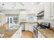 Bright eat-in kitchen featuring granite countertops, an island with seating, and stainless steel appliances at 174 Revetment Ln, Mount Pleasant, SC 29464