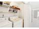 Functional laundry room area with open shelving and washer and dryer at 174 Revetment Ln, Mount Pleasant, SC 29464