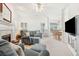 Bright living room with fireplace, plush seating, and open floor plan to the dining area at 174 Revetment Ln, Mount Pleasant, SC 29464