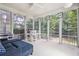 Bright sunroom enclosed with many windows and a cozy sitting area at 174 Revetment Ln, Mount Pleasant, SC 29464