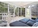 Bright sunroom enclosed with many windows and a modern white ceiling fan at 174 Revetment Ln, Mount Pleasant, SC 29464