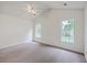 Spacious carpeted bedroom features vaulted ceilings, a ceiling fan, and two sunlit windows at 206 Barnwell St, Summerville, SC 29483
