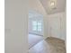 Bright entryway with tiled floor leading to a carpeted living area and a white front door at 206 Barnwell St, Summerville, SC 29483