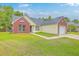Inviting single-story home with a mix of brick and vinyl siding, a well-kept lawn and a driveway at 206 Barnwell St, Summerville, SC 29483