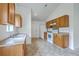 Traditional-style kitchen featuring tiled floors, wooden cabinets, white appliances, and a double sink at 206 Barnwell St, Summerville, SC 29483