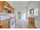 Spacious kitchen boasts oak cabinets, tiled floors, white appliances, with eat-in dining space at 206 Barnwell St, Summerville, SC 29483