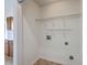Bright laundry room with washer/dryer hookups and wire shelving at 206 Barnwell St, Summerville, SC 29483