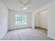 Carpeted living room featuring a ceiling fan and a large window for natural light and views of the outdoors at 206 Barnwell St, Summerville, SC 29483