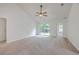 Spacious living room with a sliding glass door to backyard, ceiling fan, and neutral-toned carpet at 206 Barnwell St, Summerville, SC 29483
